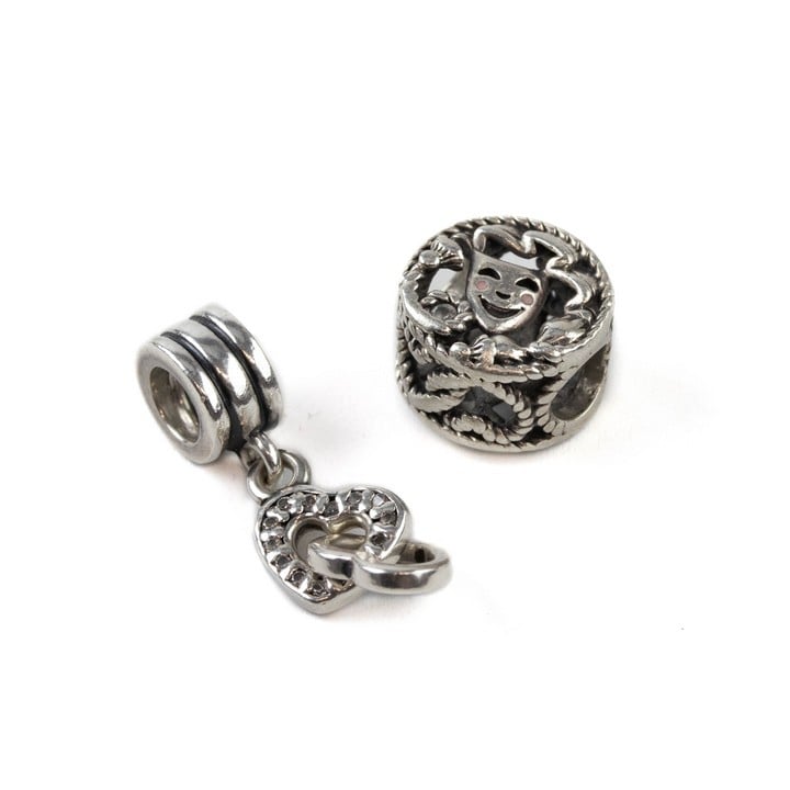 Pandora Silver Comedy and Tragedy Drama Masks Charm, Pandora Silver Interlocking Hearts Drop Charm, total weight 4.5g (VAT Only Payable on Buyers Premium)