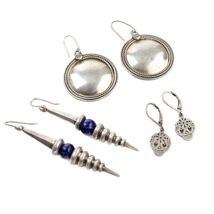 Silver Disc Drop Earrings, 5x3cm. Silver Skull Drop Earrings, 3x1cm (Slight Damage to one Earring). Silver Blue Stone Corkscrew Drop Earrings, 6.8x0.9cm, total weight 27.2g (VAT Only Payable on Buyer