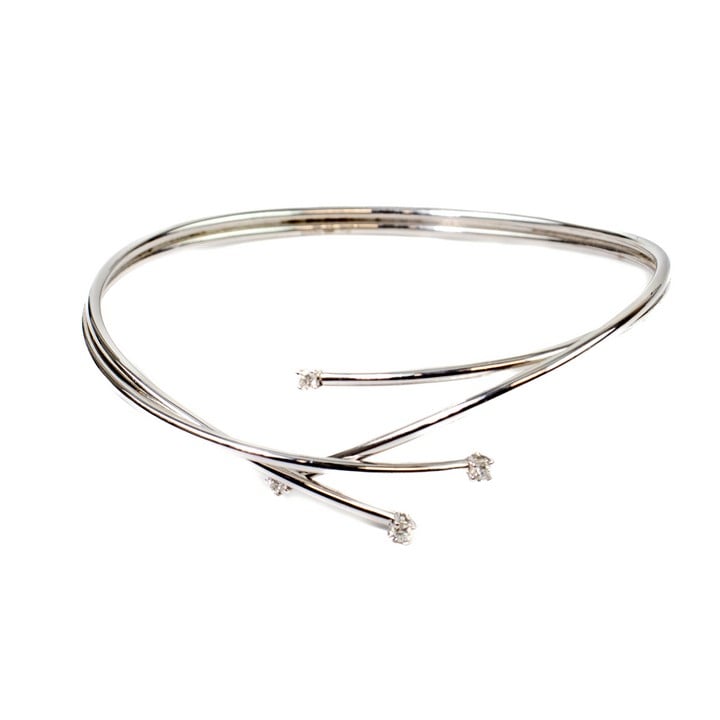 18ct White Gold 0.16ct Diamond Crossover Bangle, 18cm, 9.5g.  Auction Guide: £500-£600 (VAT Only Payable on Buyers Premium)