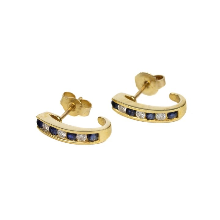 18ct Yellow Gold 0.12ct Diamond and Blue Stone half hoop Earrings 3.1g.  Auction Guide: £150-£200 (VAT Only Payable on Buyers Premium)