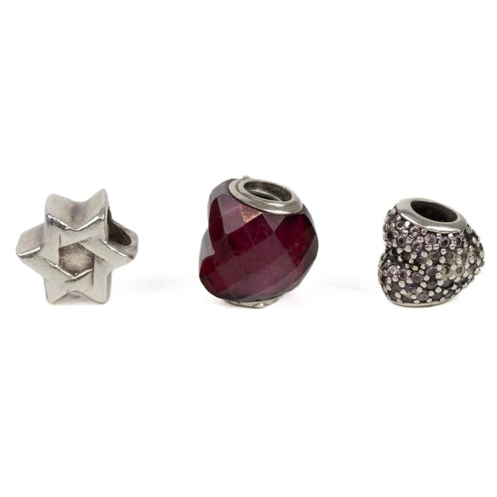 Pandora Silver Three Charms including Red Faceted Bead, Pink Stone Pavé Heart, Star, total weight 6.9g (VAT Only Payable on Buyers Premium)