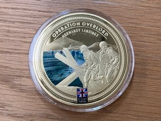 AN OPERATION OVERLORD OVERSIZED GOLD PLATED COMMEMORATIVE COIN WITH CERTIFICATE: LOCATION - CR