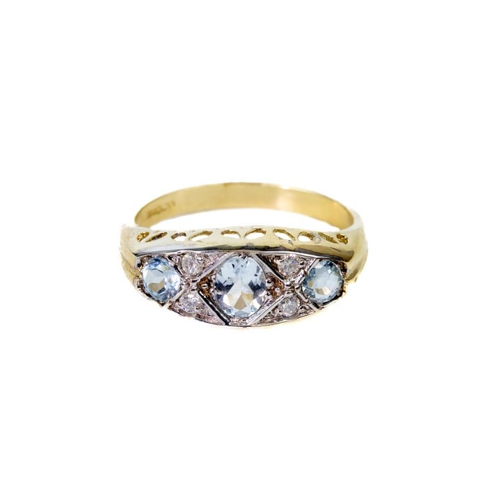 9ct Yellow and White Gold 0.70ct Blue Topaz and 0.12ct Diamond Band Ring, Size O½, 2.7g.  Auction Guide: £200-£300